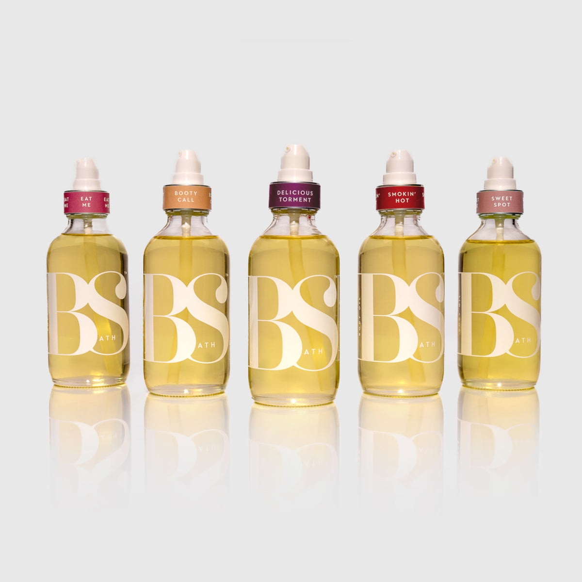 Bath Slut body oils in five scents: Booty Call, Delicious Torment, Eat Me, Smokin' Hot and Sweet Spot, 4 oz glass pump bottles