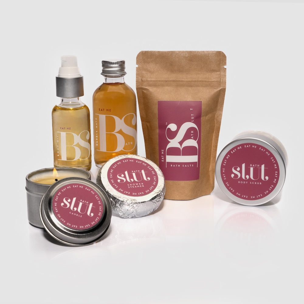 Bath Slut travel-size bath and body gift set in Eat Me, with notes of vanilla bean, magnolia and patchouli: bubble bath, bath salts, body scrub, body oil, shower steamer and soy candle
